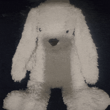 a white stuffed bunny with a black nose