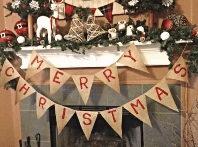 a banner that says merry christmas hangs on a fireplace