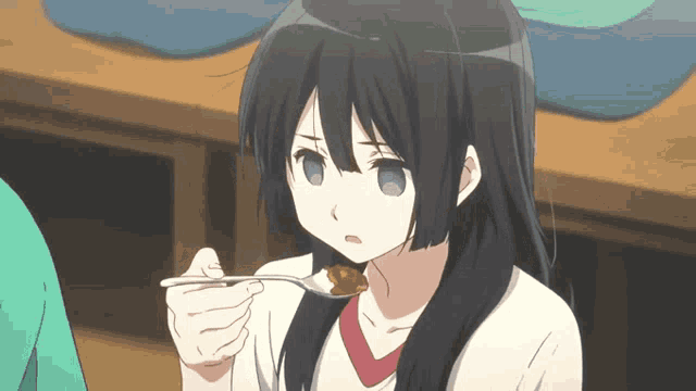 a girl with long black hair is holding a spoon