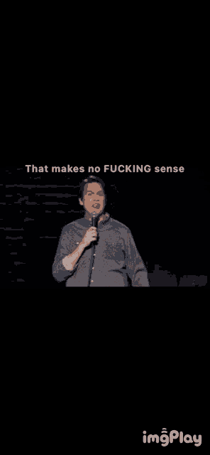 a man stands in front of a microphone and says that makes no fucking sense ..