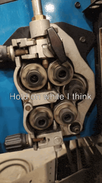 a machine with the words hold on while i think written on it