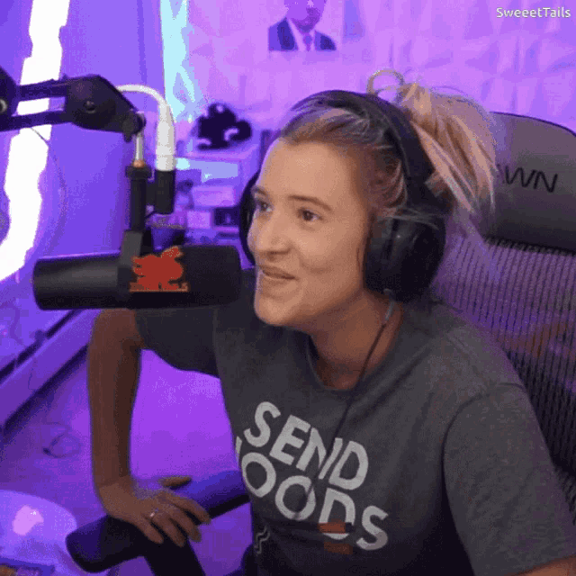 a woman wearing headphones and a send goods t-shirt