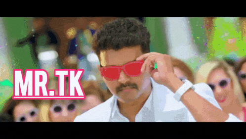 a man wearing sunglasses and a mustache is standing in front of a group of women with the words mr.tk above him