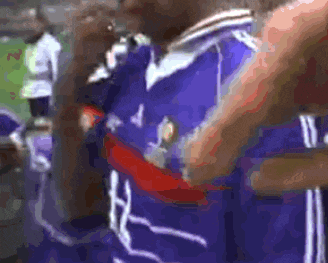 a blurry picture of a person wearing a blue jersey with the number 4