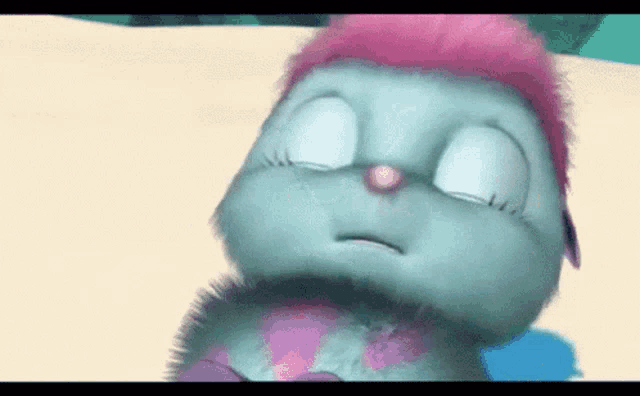a cartoon bunny with pink hair is sleeping on the beach .