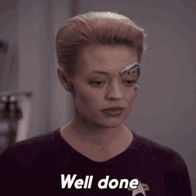 a woman with a robotic face has the word well done on her chest