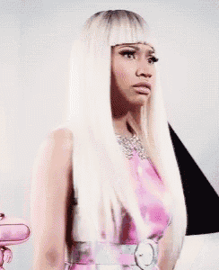 a woman with long blonde hair is wearing a pink dress and a necklace .