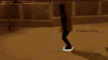 a person is riding a glow in the dark skateboard on a street .