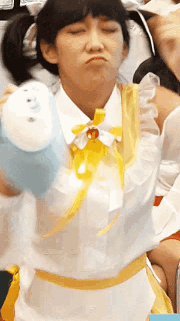 a woman wearing a white shirt and a yellow apron