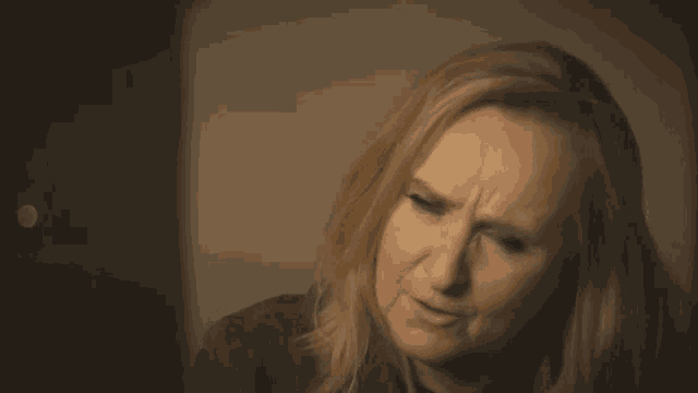 a close up of a woman making a face with her eyes closed