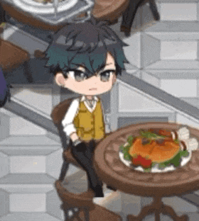 a little boy is sitting at a table with a plate of food on it .