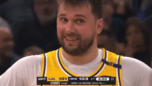a basketball player wearing a jersey that says espn is smiling
