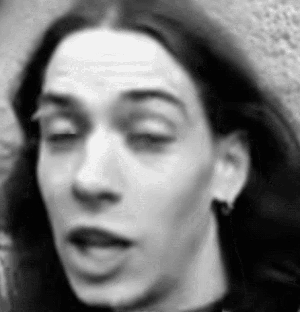 a black and white photo of a woman with long hair