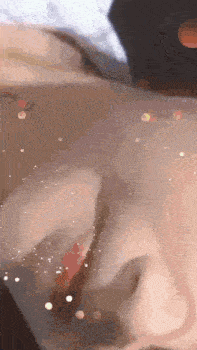 a close up of a person 's face with a blurred background .