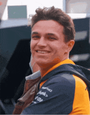a young man wearing a shirt that says damtrace on it smiles