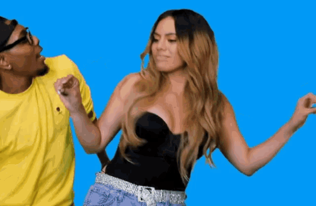 a man and a woman are dancing on a blue background .