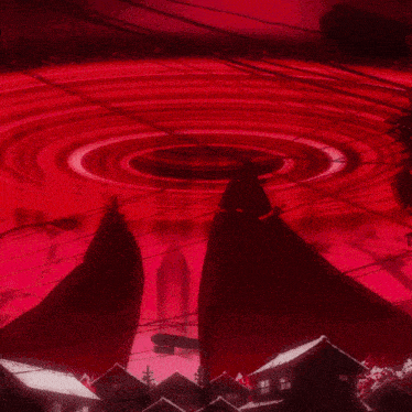 a group of people are standing in front of a large red light