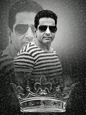 a man wearing sunglasses and a striped shirt with a crown in the background