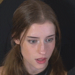 a close up of a woman making a funny face with her mouth open