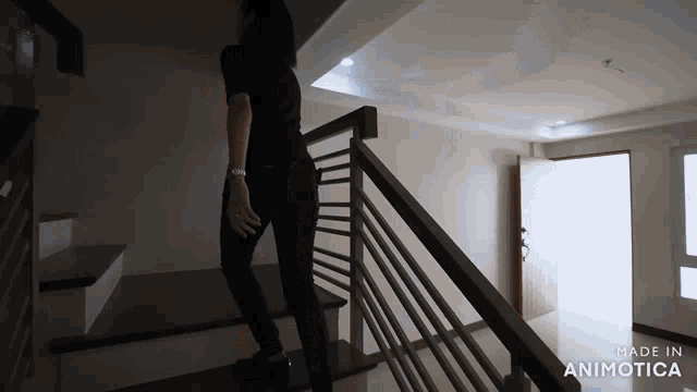 a woman is walking down a set of stairs with the words made in animatica on the bottom