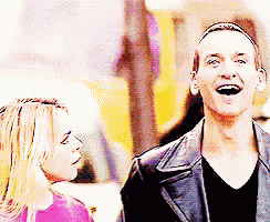 a man and a woman are standing next to each other and the man is laughing