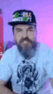 a man with a beard wearing a hat and a t-shirt with a picture of a bear on it