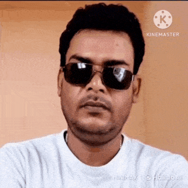 a man wearing sunglasses and a white t-shirt is making a funny face .