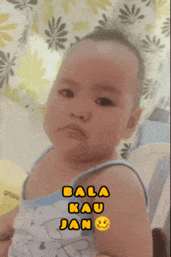 a baby with the words bala kau jan written on his chest