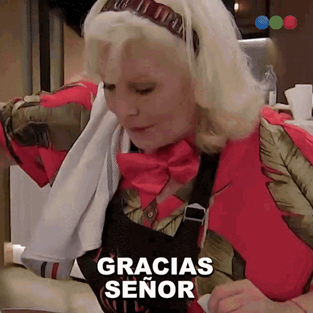 a woman says gracias señor while looking down at something