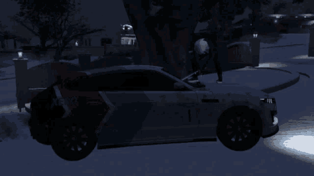 a white xeno car is parked in the snow at night