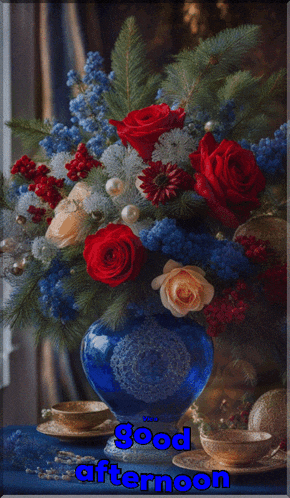 a bouquet of red and blue flowers in a blue vase with the words good afternoon