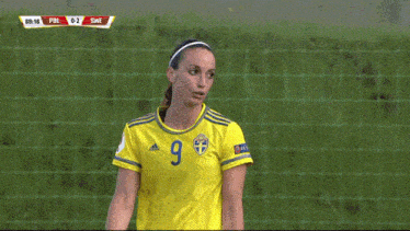 two female soccer players giving each other a high five during a game