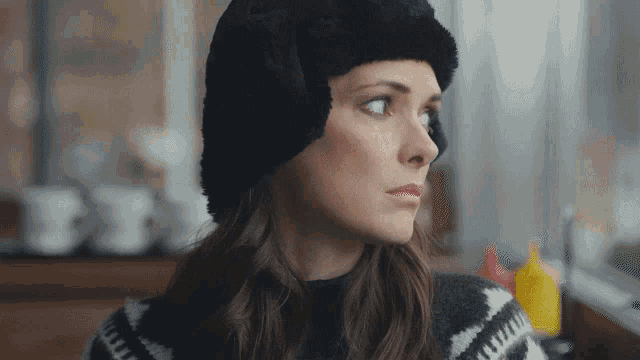 a woman wearing a fur hat and ear muffs