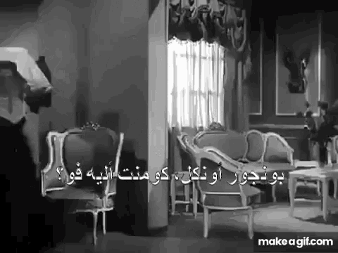 a black and white photo of a living room with a couch and chairs