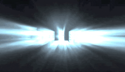 a dark room with a light coming through the doors