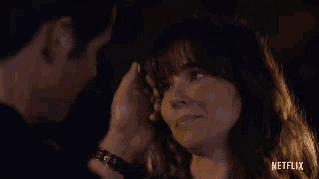 a man and a woman are looking at each other in a netflix ad