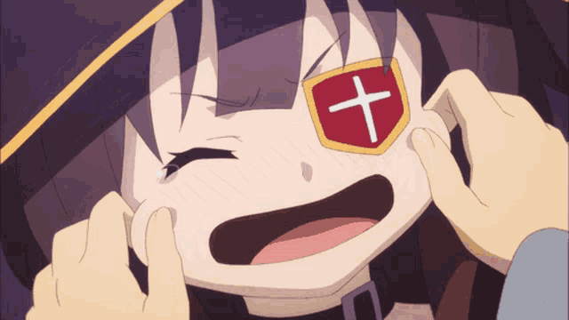 a girl with a cross on her eye is being touched by someone