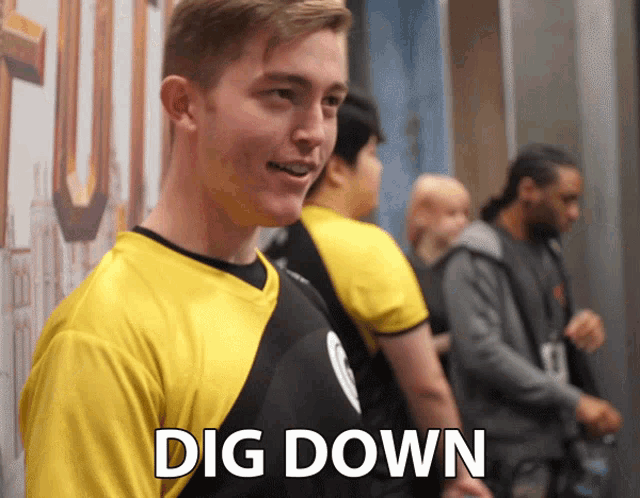 a man in a yellow shirt with the words dig down written on it