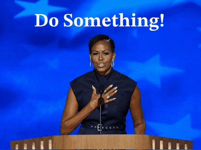 michelle obama stands at a podium with the words do something written above her