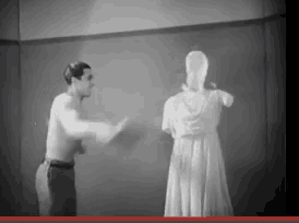 a man is standing next to a statue of a woman