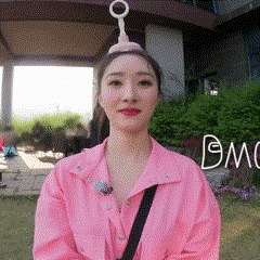 a woman wearing a pink jacket and a bubble hat