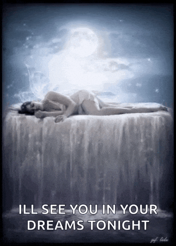 a woman is laying on a bed with a waterfall in the background .