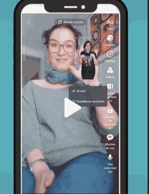 a phone screen shows a woman with glasses and the word aa on it