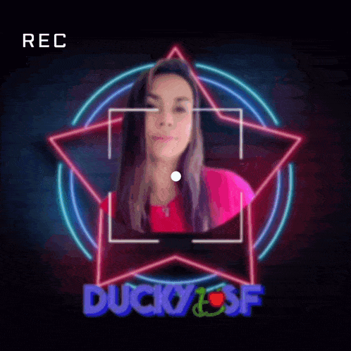 a woman 's face is being recorded in front of a duck and sf logo