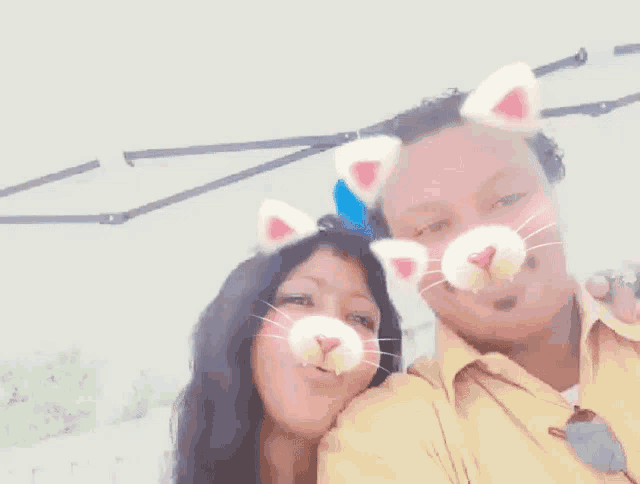 a man and a woman with cat ears on their face