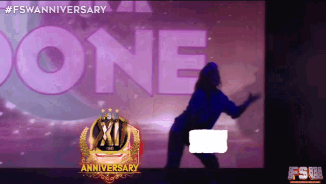 a woman is dancing in front of a screen that says one on it