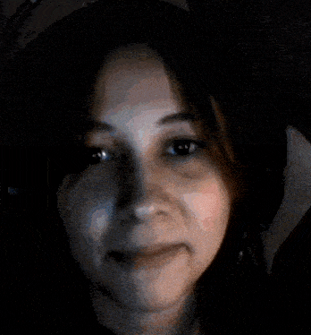 a close up of a woman wearing headphones and making a face