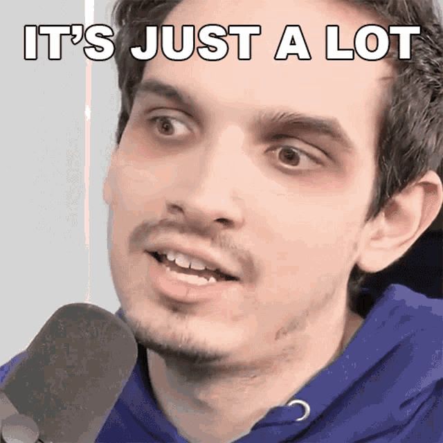 a man talking into a microphone with the words it 's just a lot written on his face