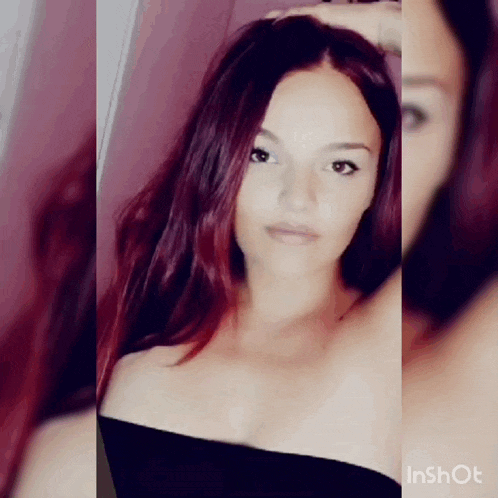 a woman with red hair is taking a selfie in a black top