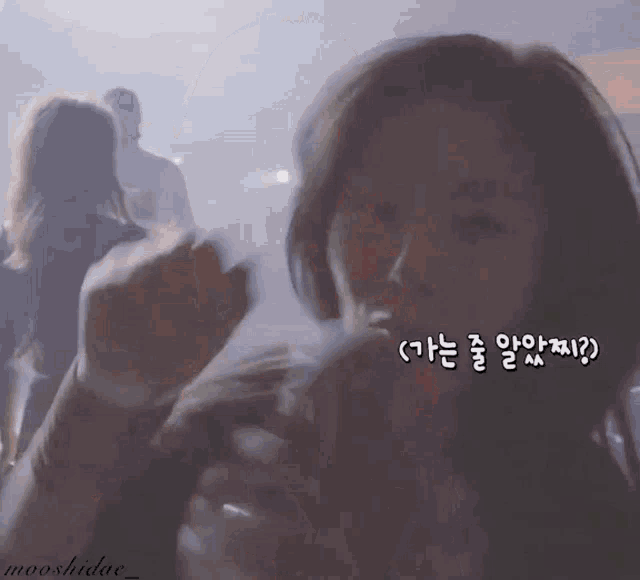 a close up of a woman 's face with korean writing